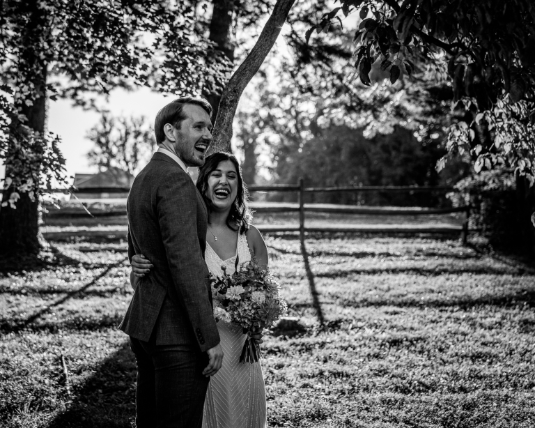 Jenna and Kevin laugh at their joyful autumnal theatre wedding at The Barns at Wolf Trap